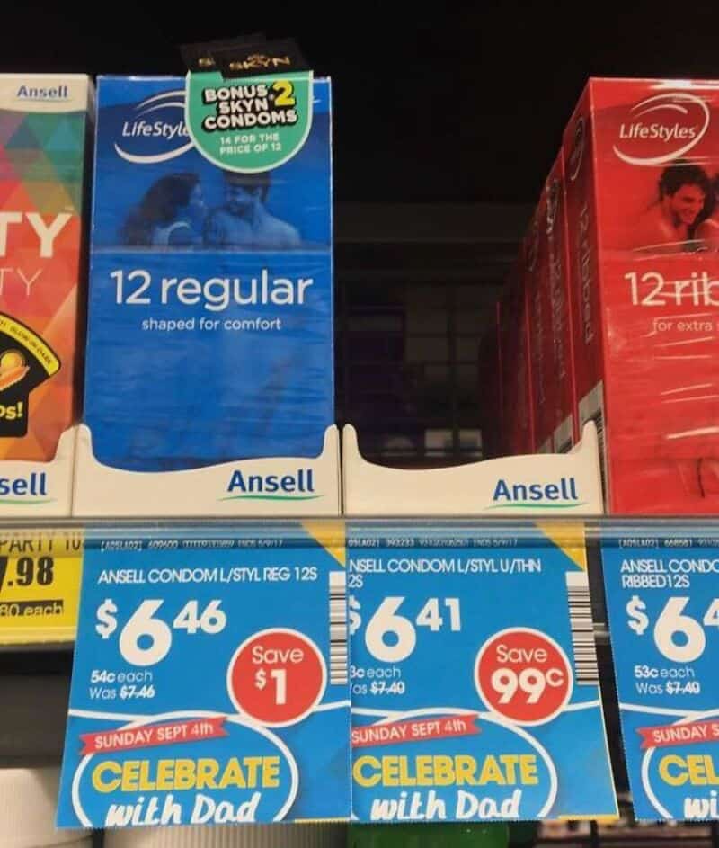 Condom packages on store shelf with promotional signs for Sunday Sept 4th.