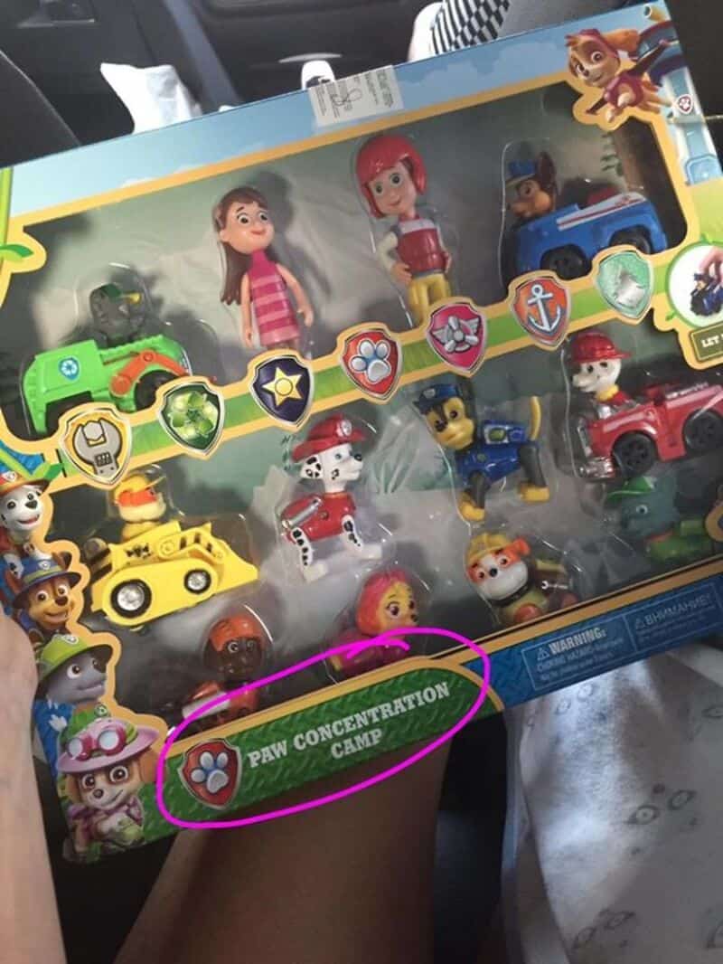 A toy set with characters and vehicles, including a sign reading 'PAW CONCENTRATION CAMP'.