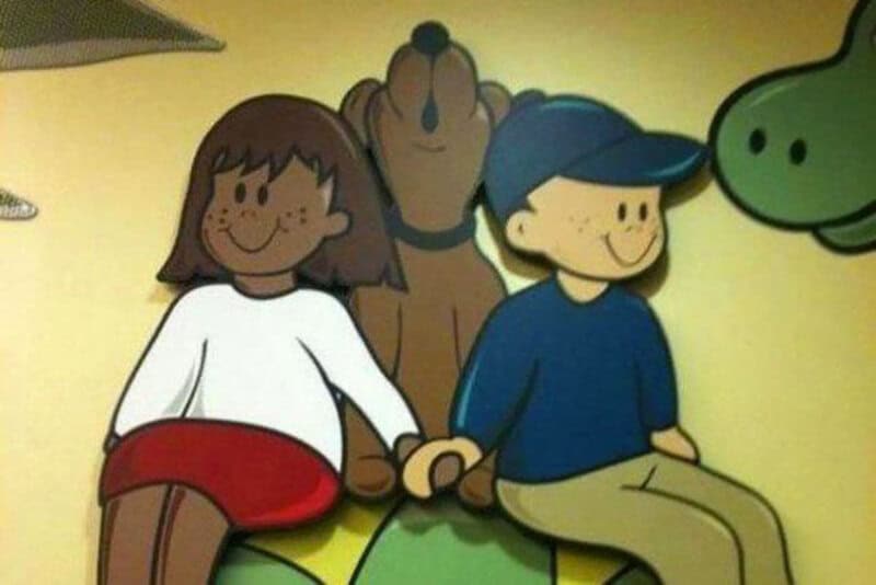 Children holding hands with cartoon characters in the background.