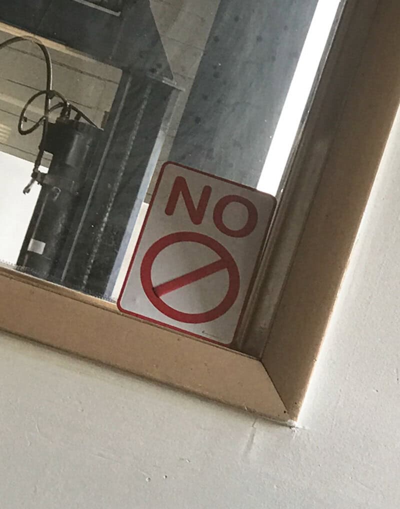Sign says 'NO' with a no symbol, but it's placed on a window.