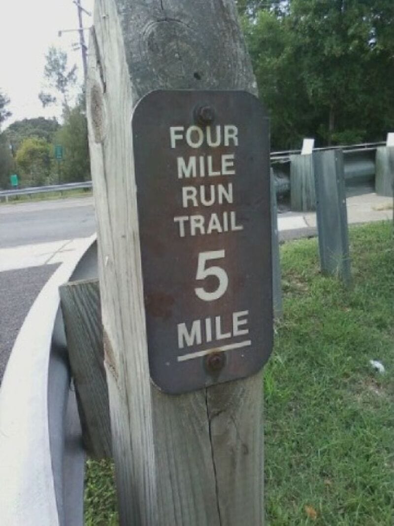 Four mile run trail 5 mile sign with a typo, 'Four mile run trail 5 mile'.