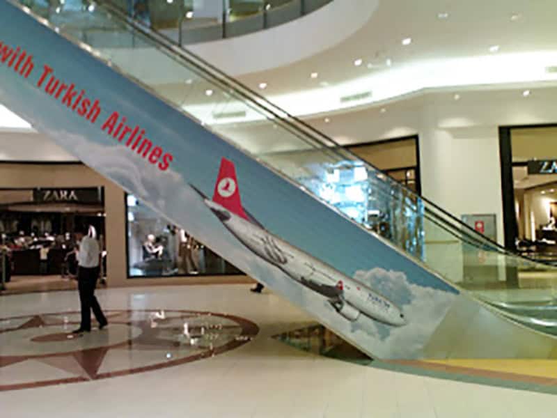 Turkish Airlines airplane appears to be falling down an escalator in a shopping mall.