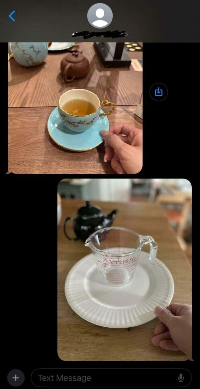A tea cup on a saucer with a hand holding a spoon, and a glass measuring cup on a plate.