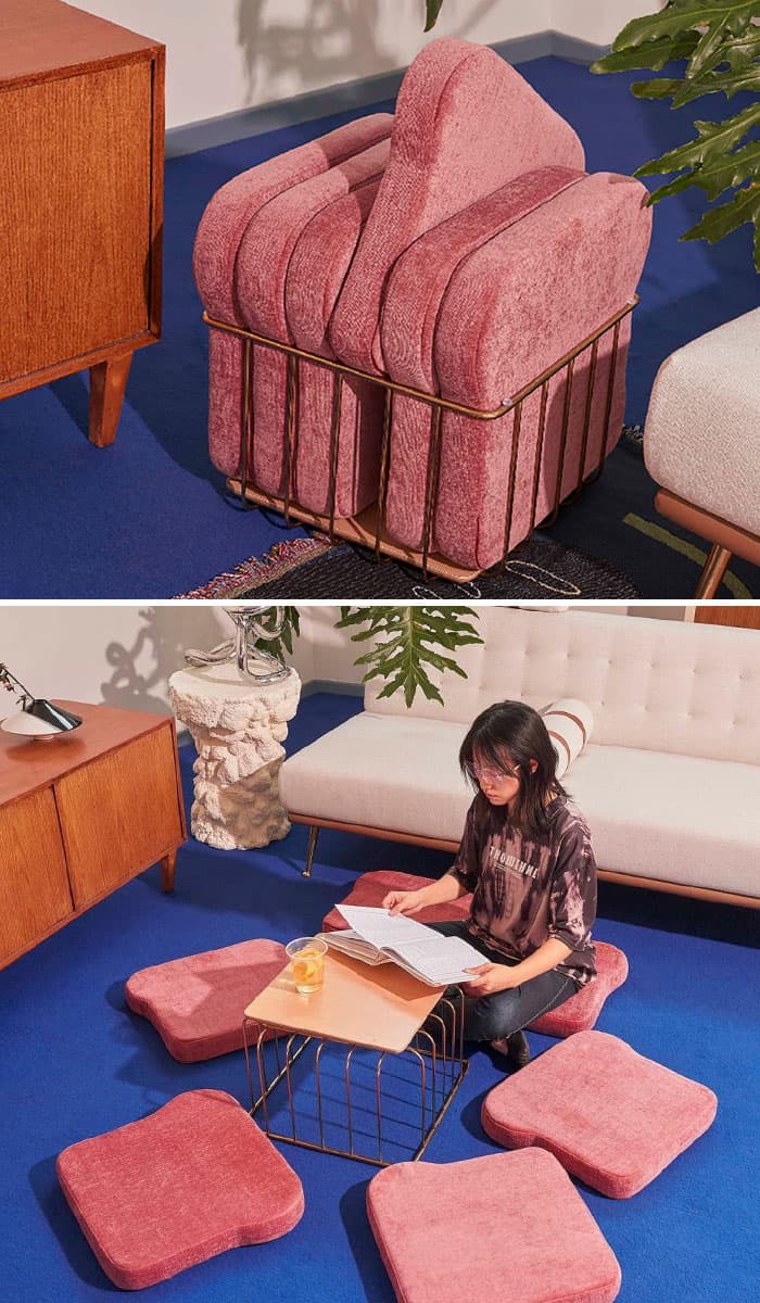 Pink armchair with a gold wire frame, stacked with matching cushions, in a modern living room.