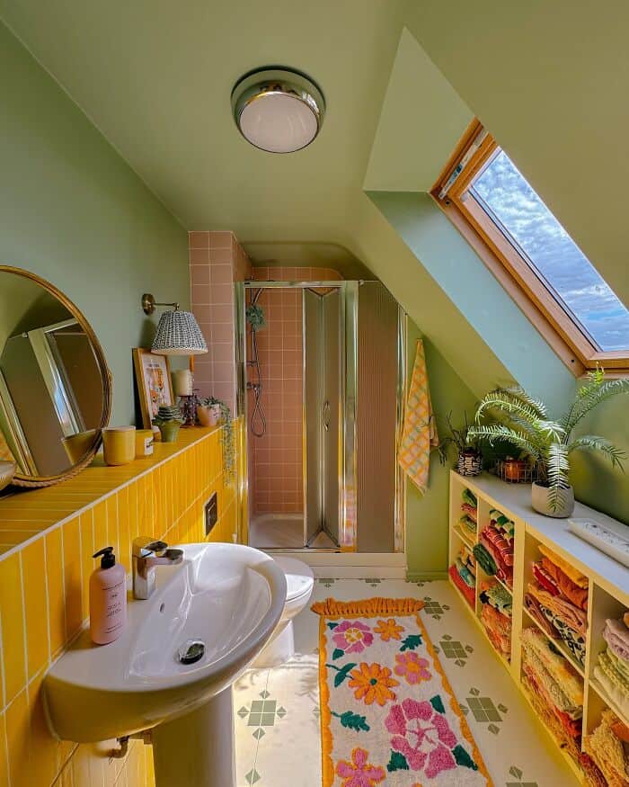 Bright green bathroom with skylight, yellow accents, and colorful rug.