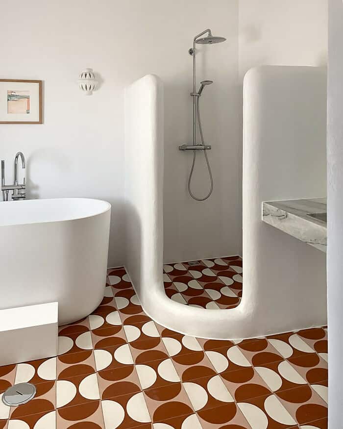 Modern bathroom with freestanding tub and walk-in shower, stylish design.