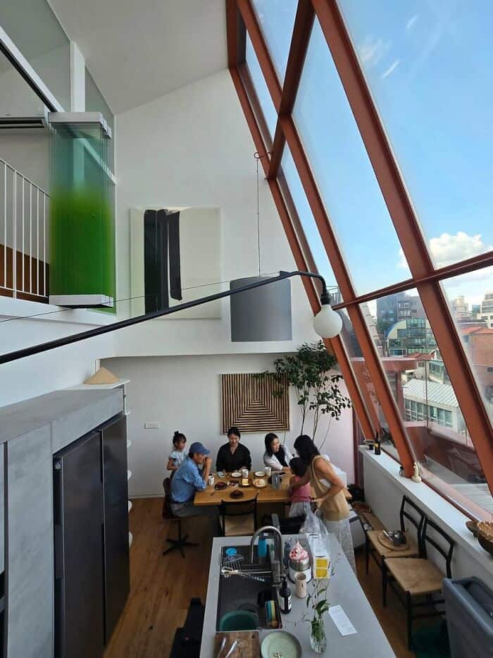 Modern cafe interior with large glass windows and seating area.