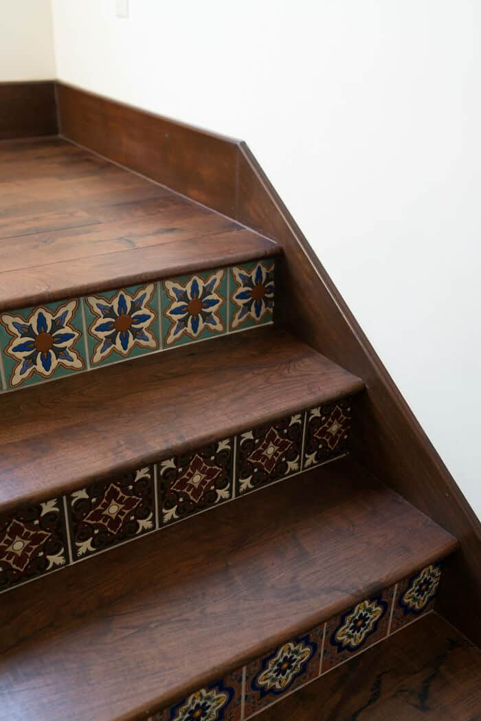 Wooden staircase with decorative tile risers and dark wood steps.