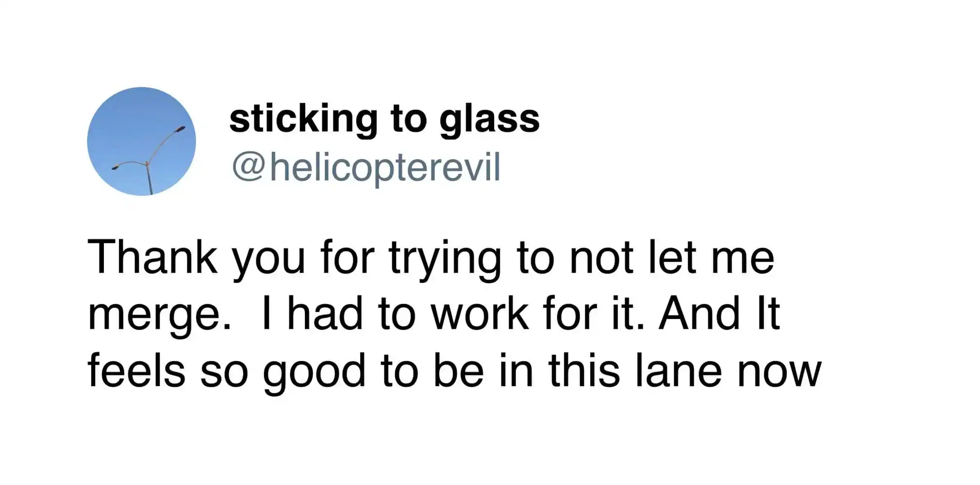 Sticking to glass, wind turbine in the sky, humorous message about merging and lane.