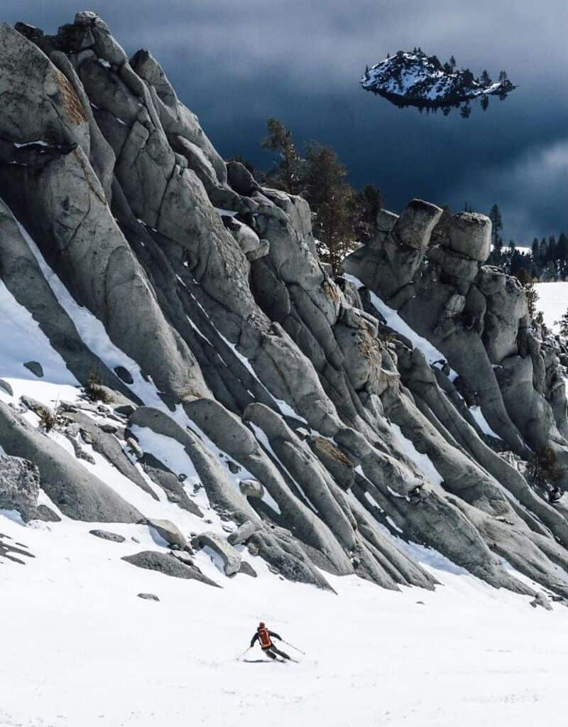 Snowy mountain landscape with a skier and a floating island in the sky.