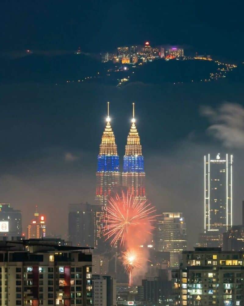 Night view of Kuala Lumpur with fireworks near Petronas Towers.