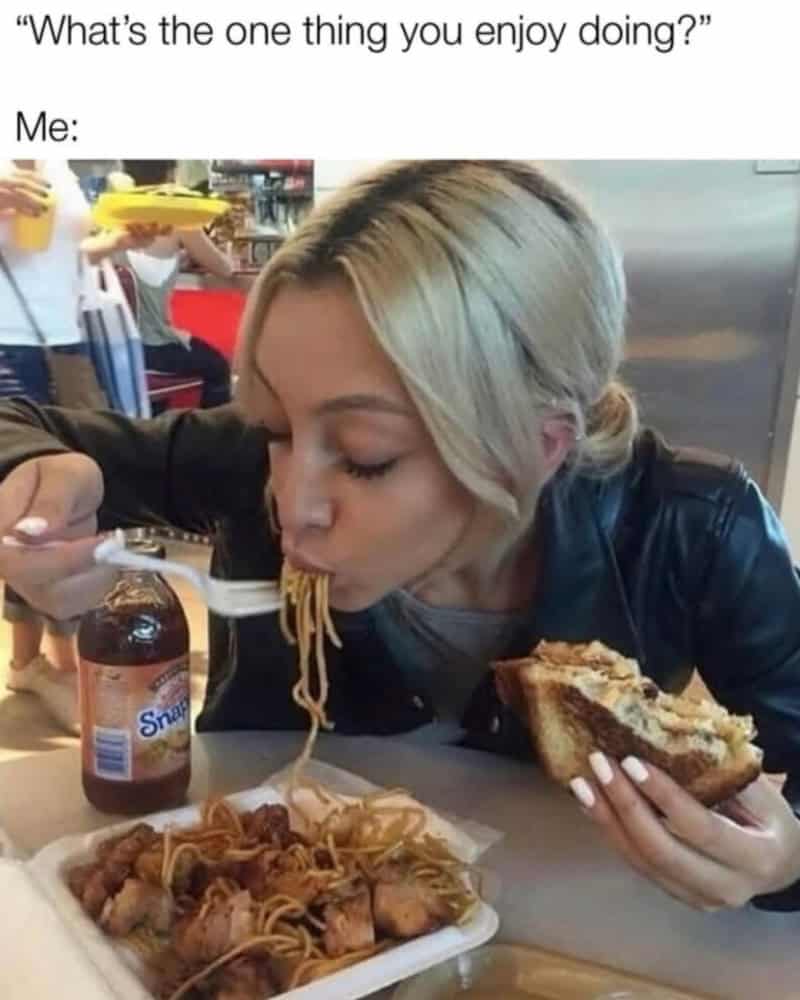 Woman eating spaghetti and holding a sandwich, with a humorous caption about enjoying doing nothing.