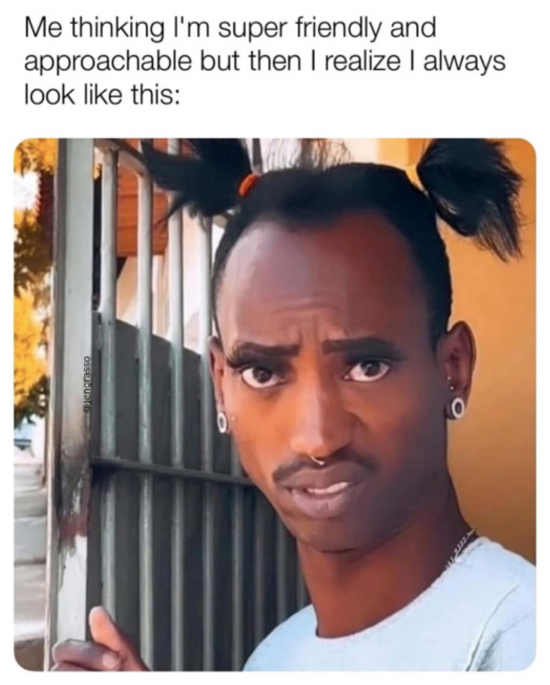 Person with pigtails and a skeptical expression, holding a gate.