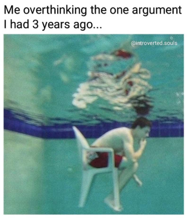 Person sitting on a chair underwater, thinking with a reflection above.