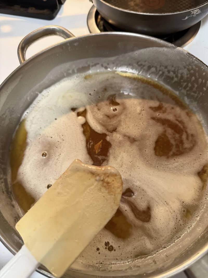 Melting butter in a saucepan on the stove with foam and bubbles.