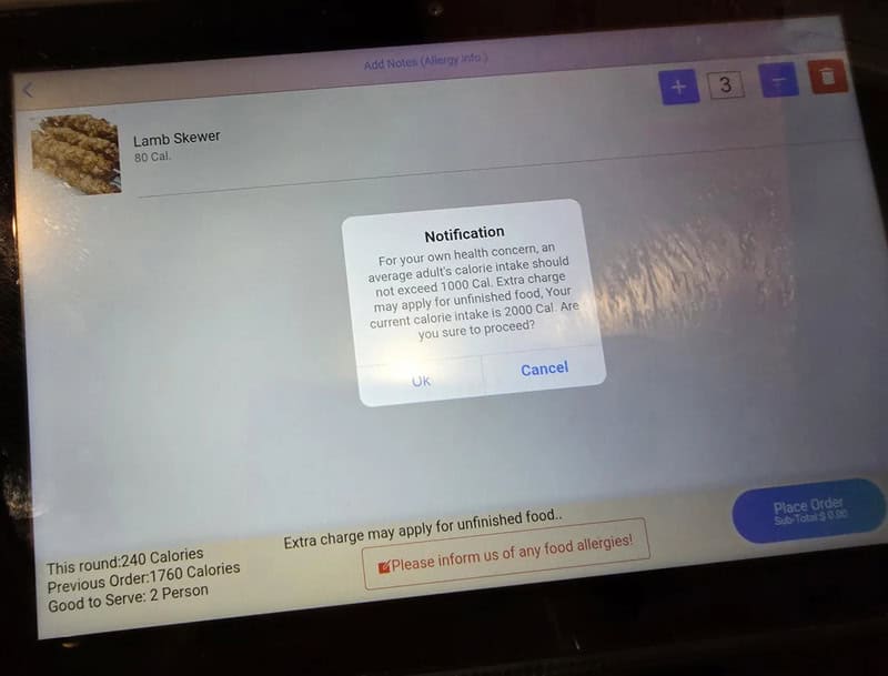 Lamb Skewer calorie tracking screen with notification popup.