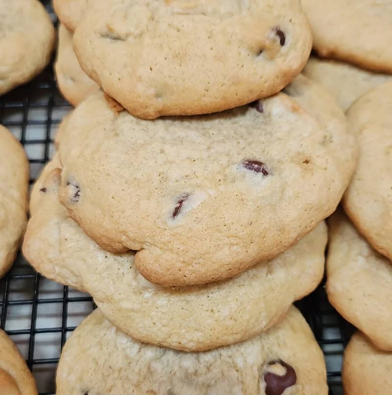 Freshly baked chocolate chip cookies cooling on a wire rack.