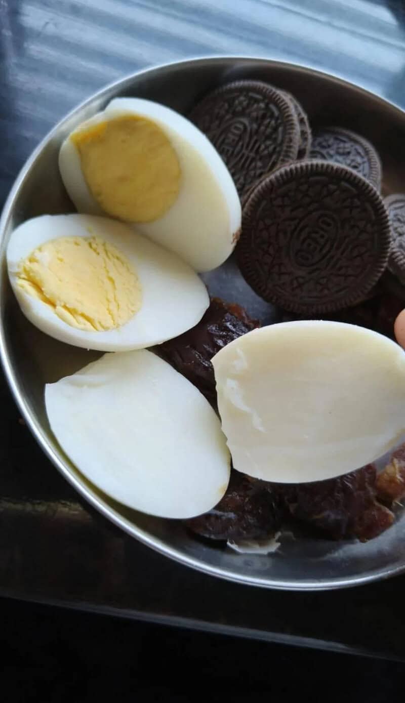 Hard-boiled eggs, Oreo cookies, and dates in a bowl.