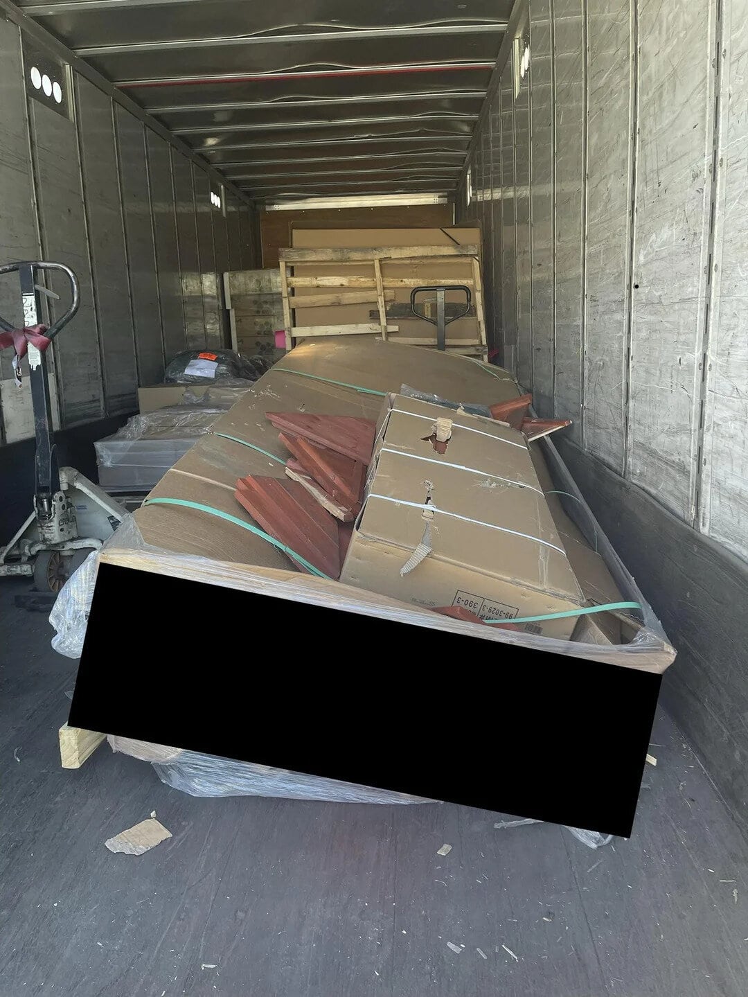 Cluttered truck with furniture and boxes, partially blocking the entrance.
