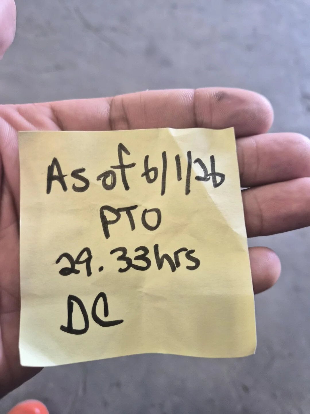 Note on a yellow sticky note reading 'As of 6/14/22 PTO 29.33 hrs DC' held by a person's hand.