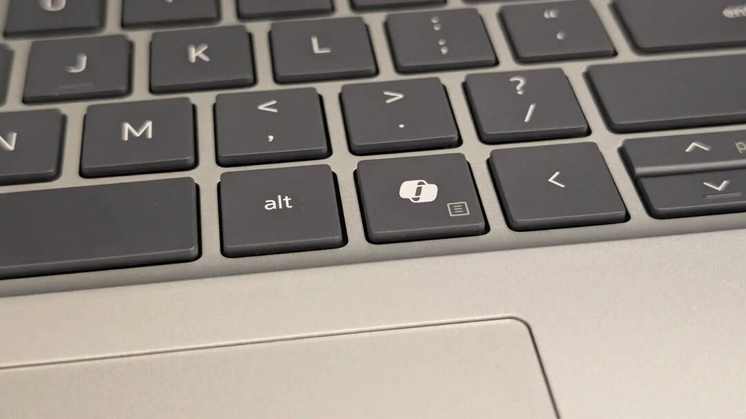 Close-up of a laptop keyboard showing the 'alt' key and a printer icon key.