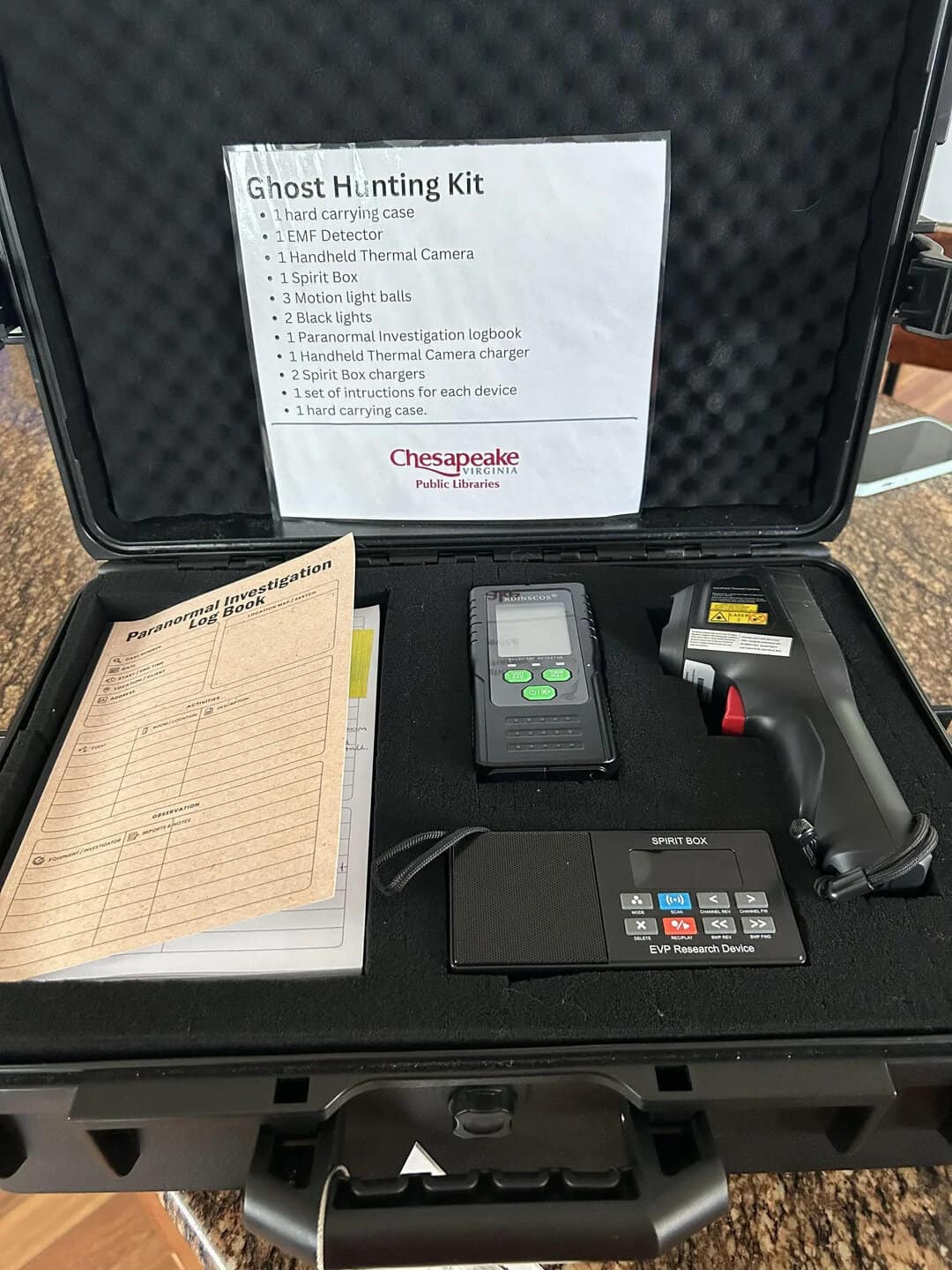 Ghost Hunting Kit in hard case with equipment and list of contents.