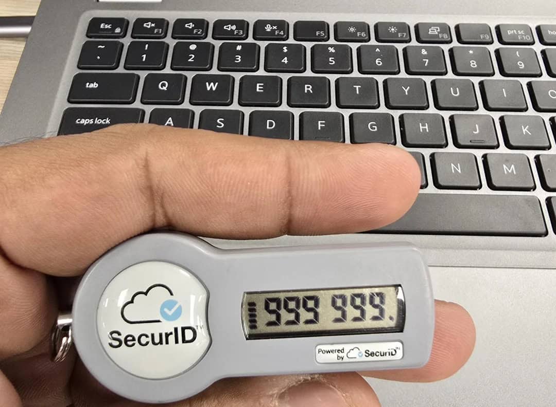 Protective security device displaying a digital code in front of a laptop keyboard.