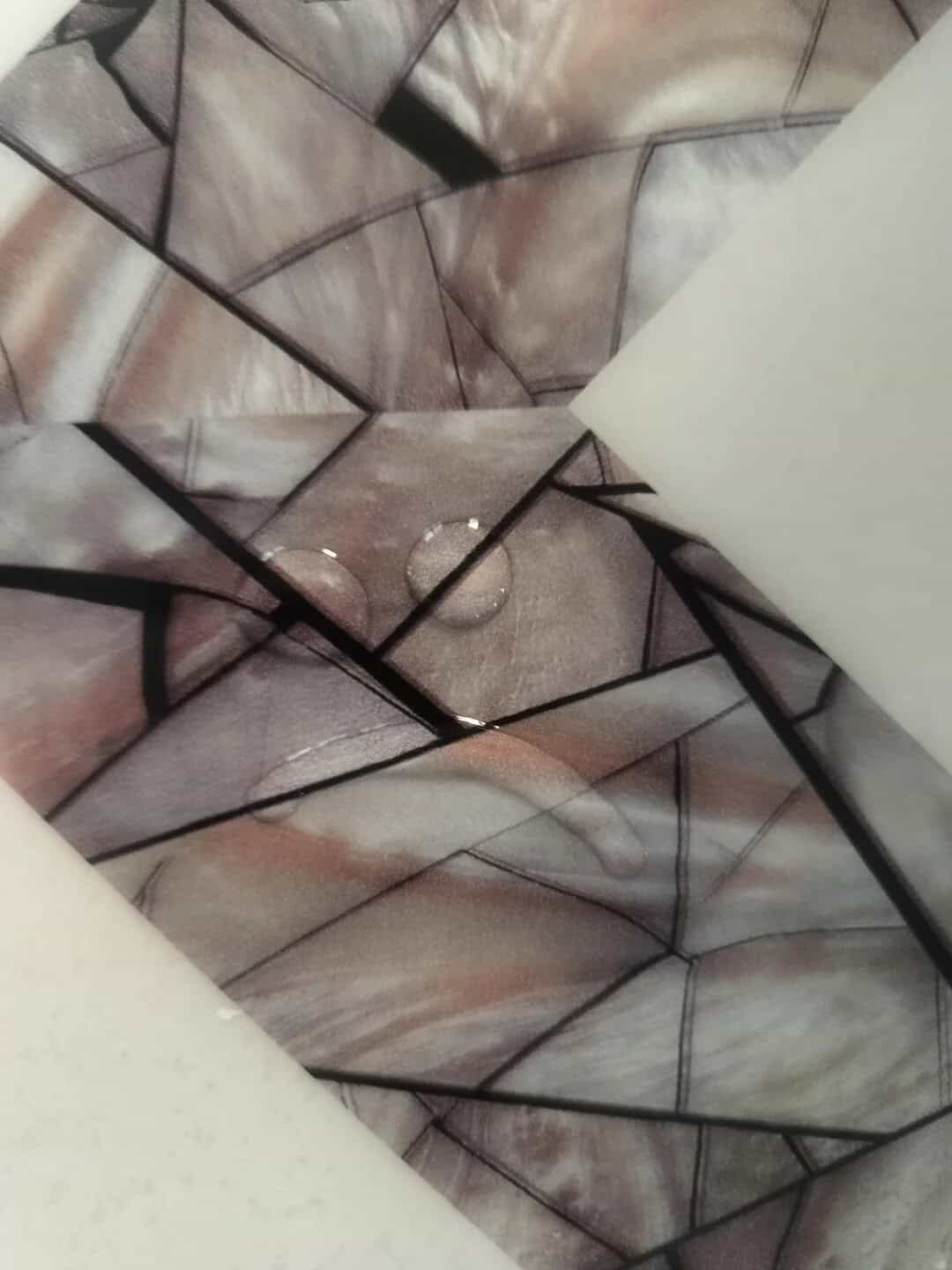 Shattered glass mosaic with geometric patterns and reflective surfaces.