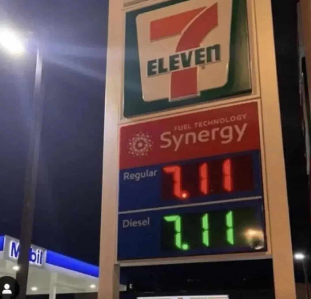 7-Eleven fuel station price sign with regular and diesel prices.