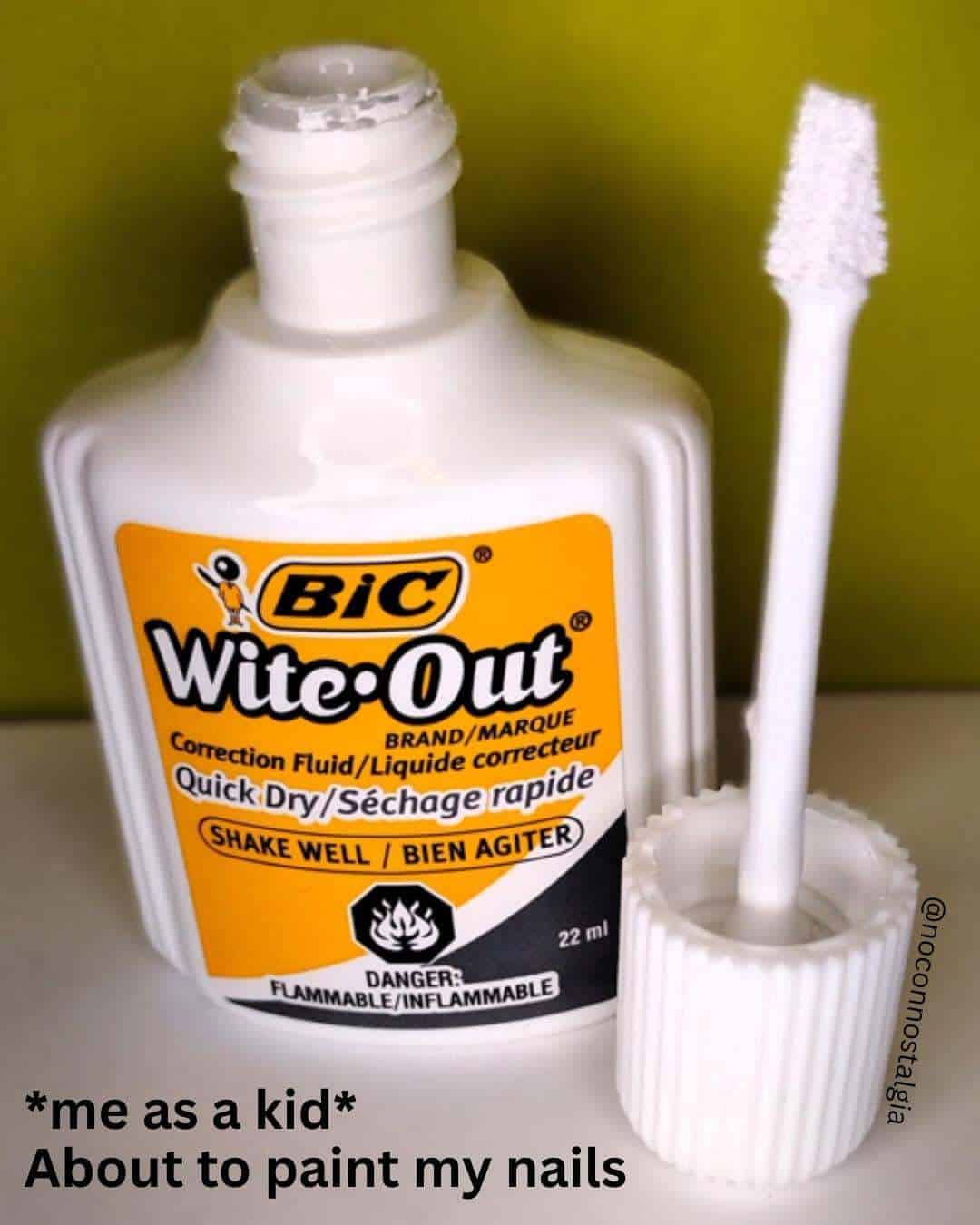 Bic Wite-Out correction fluid bottle with brush applicator, against a green background.