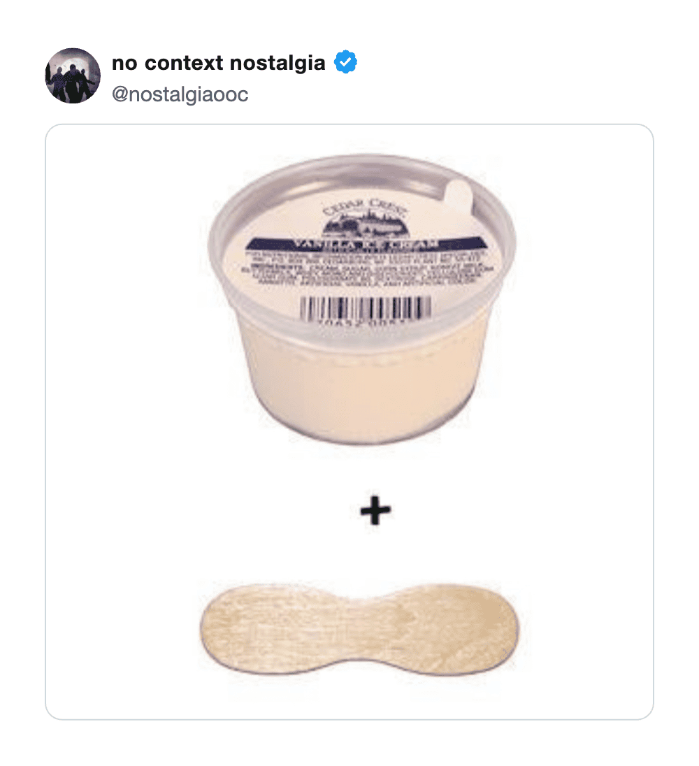 Cream cheese container with a wooden spreader below it.