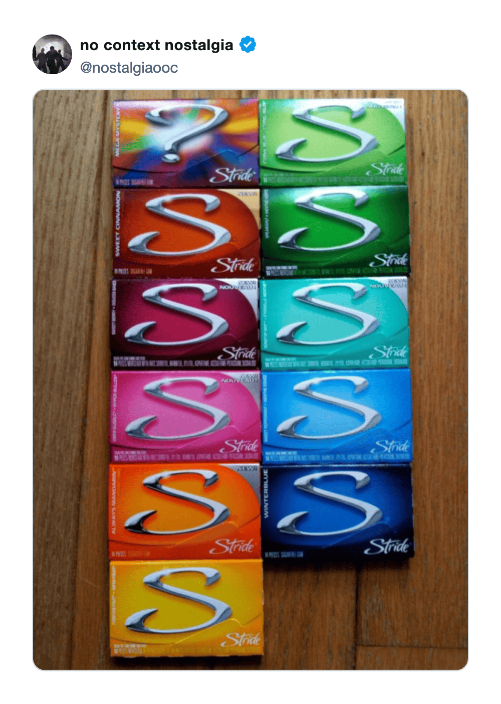 Colorful boxes of Strike S chewing gum arranged on a wooden surface.