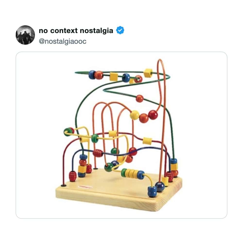 Brightly colored bead maze toy on a wooden base with multiple wire tracks.