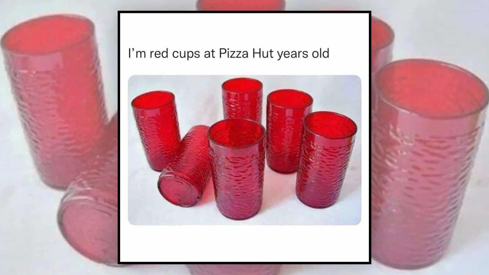 Red cups at Pizza Hut, some are stacked and some are lying down.