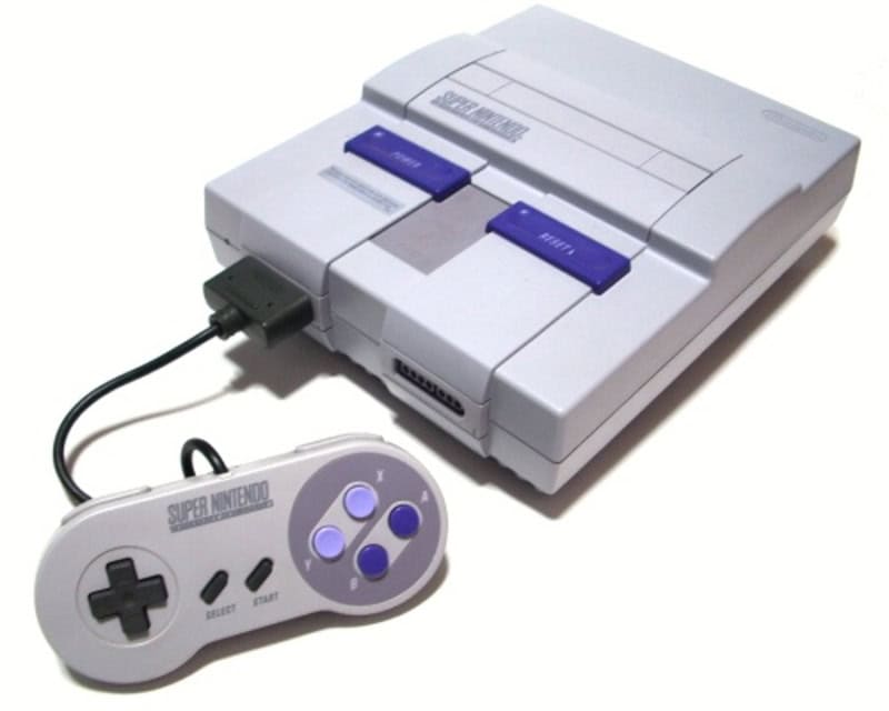 Super Nintendo Entertainment System with controller, classic gaming console from the 90s.