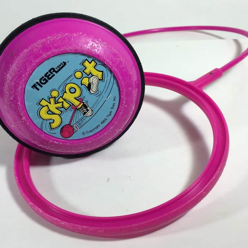 Pink toy with a stethoscope and a label reading 'Skip-It' from the 90s.