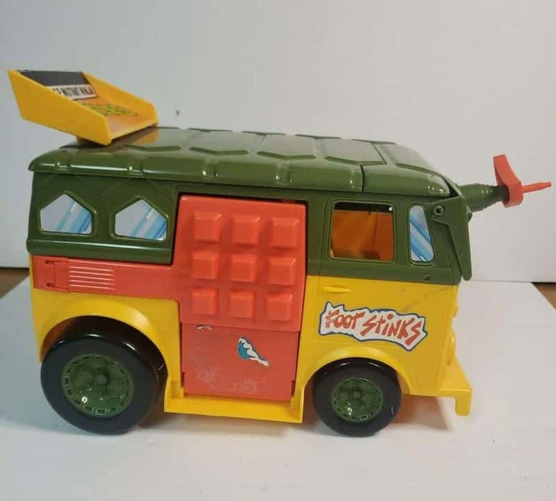Foot Stinks toy van with green roof, yellow body, and orange door from 90s toys.