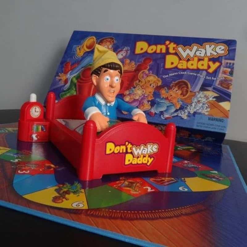 Don't Wake Daddy board game with a plastic figure in bed and colorful game board.