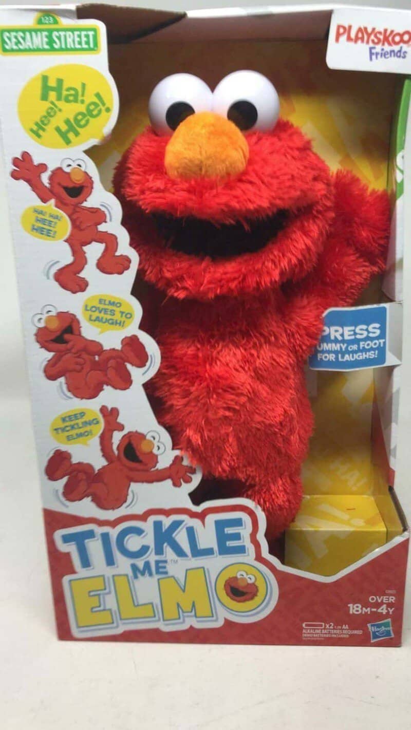 Elmo plush toy from Sesame Street in packaging, with colorful box and character images.