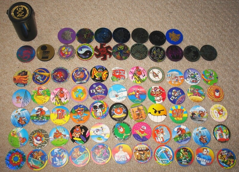 Collection of 60 vintage 90s toy tokens and discs from the '90s toys post.