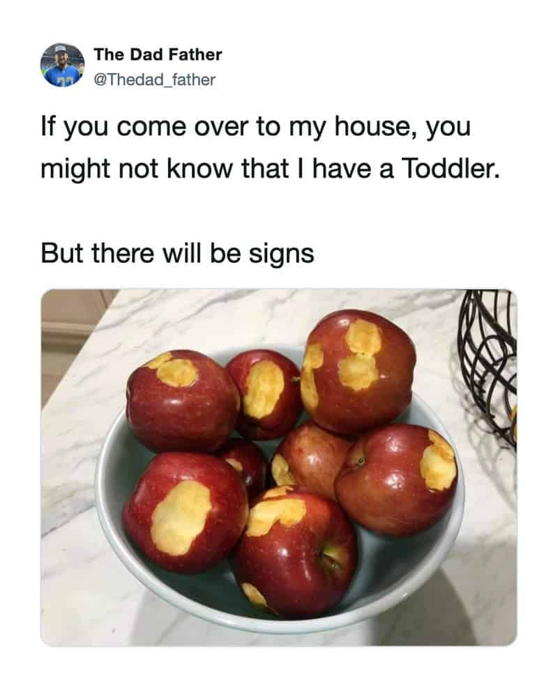 A bowl of apples with yellow patches, indicating a toddler's bites.