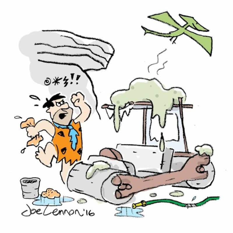 Fred Flintstone from The Flintstones with a broken car and a falling tree branch.