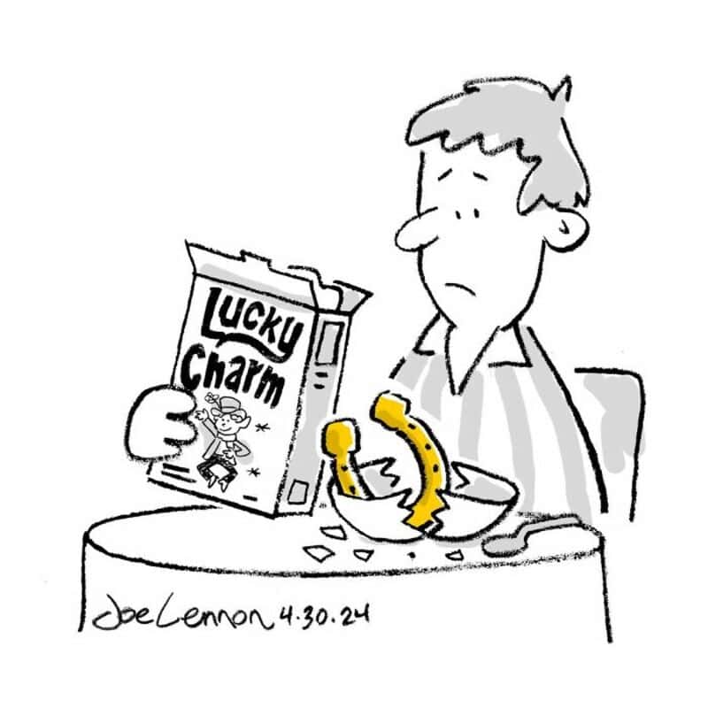 Person with a sad expression holds a Lucky Charm cereal box and a broken yellow telephone.