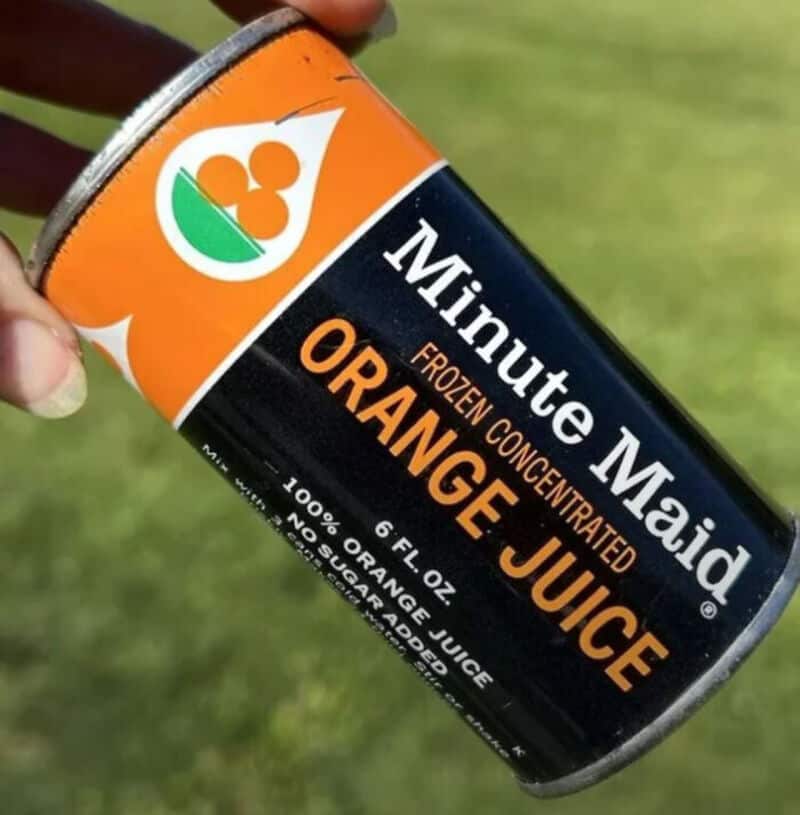 A can of Minute Maid Frozen Concentrated Orange Juice held outdoors.