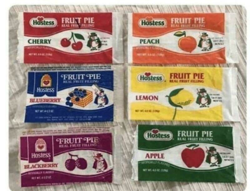 Assorted Hostess fruit pie packages with flavors: cherry, peach, blueberry, lemon, blackberry, and-.