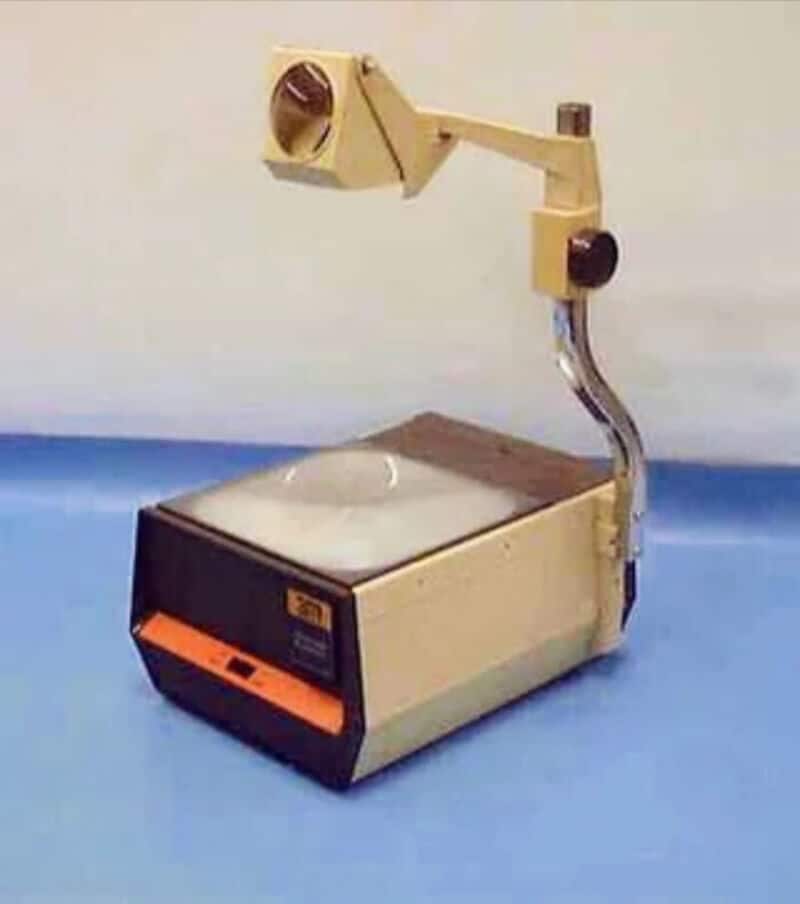 Vintage scientific instrument with a beige and black body and a mounted adjustable arm.