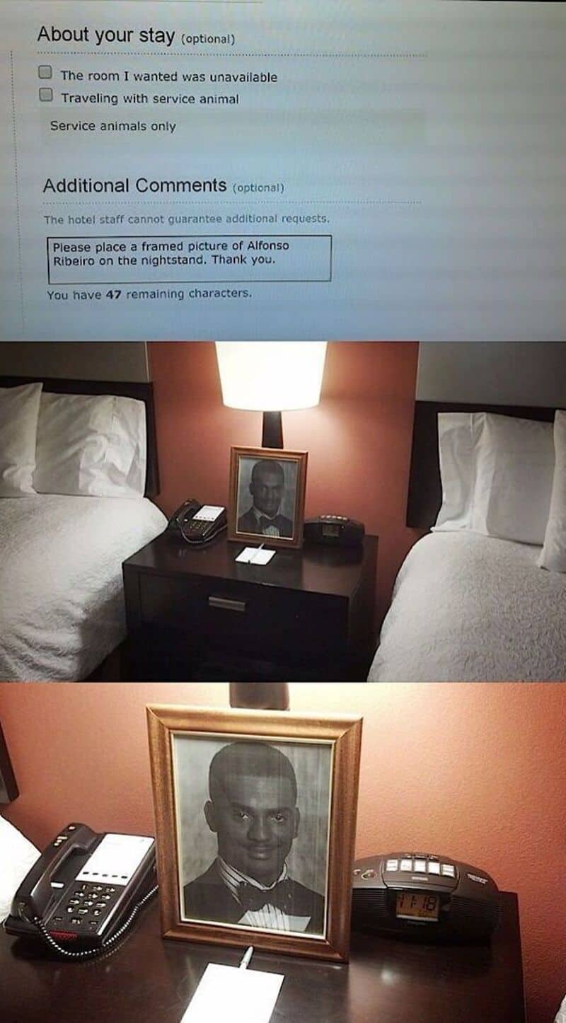 Hotel room with two beds, a nightstand, and a framed photo of a man in a tuxedo.