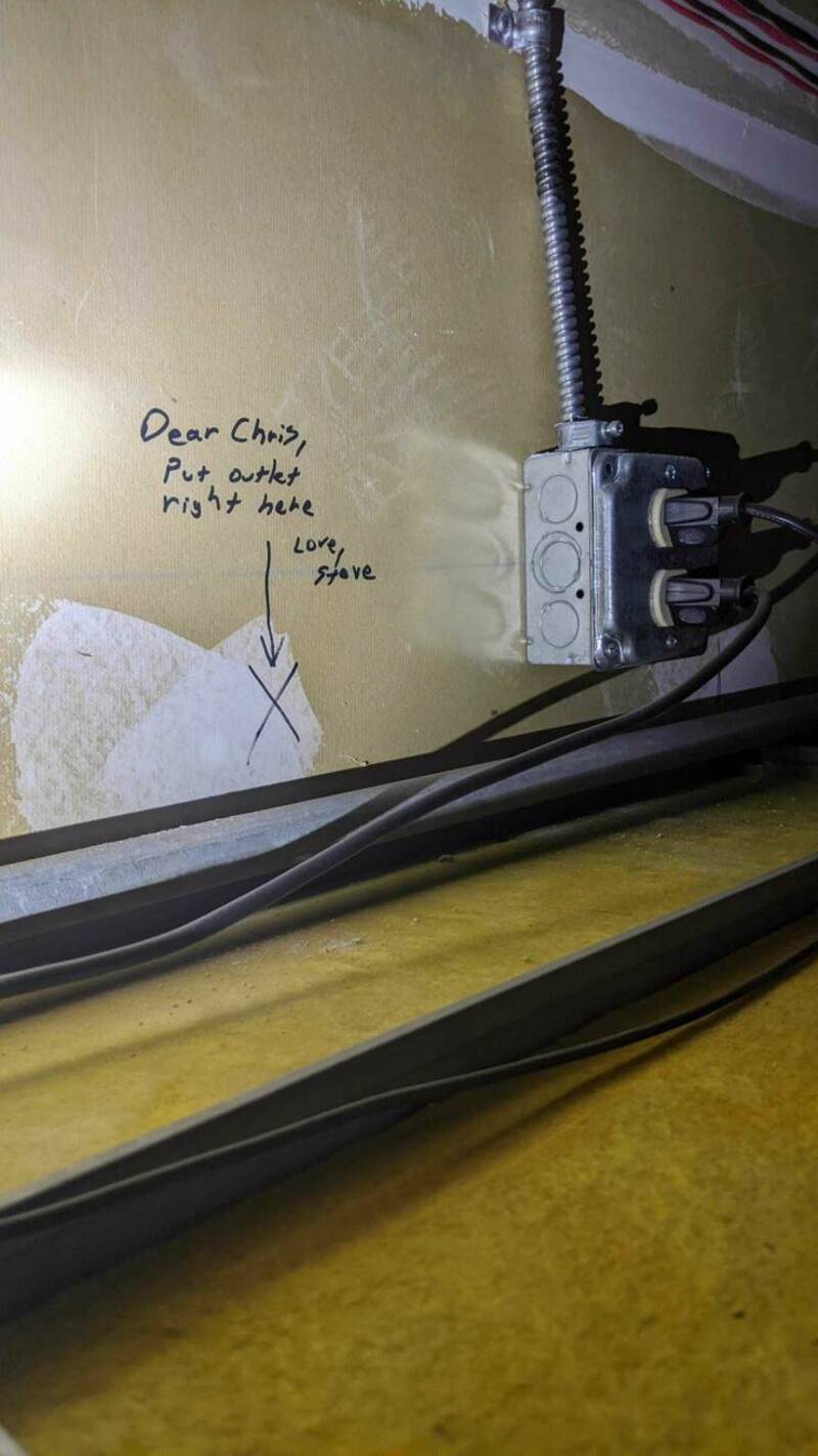 Handwritten note on wall says, 'Dear Chizi, Put another right here. Love, Steve' near electrical box.