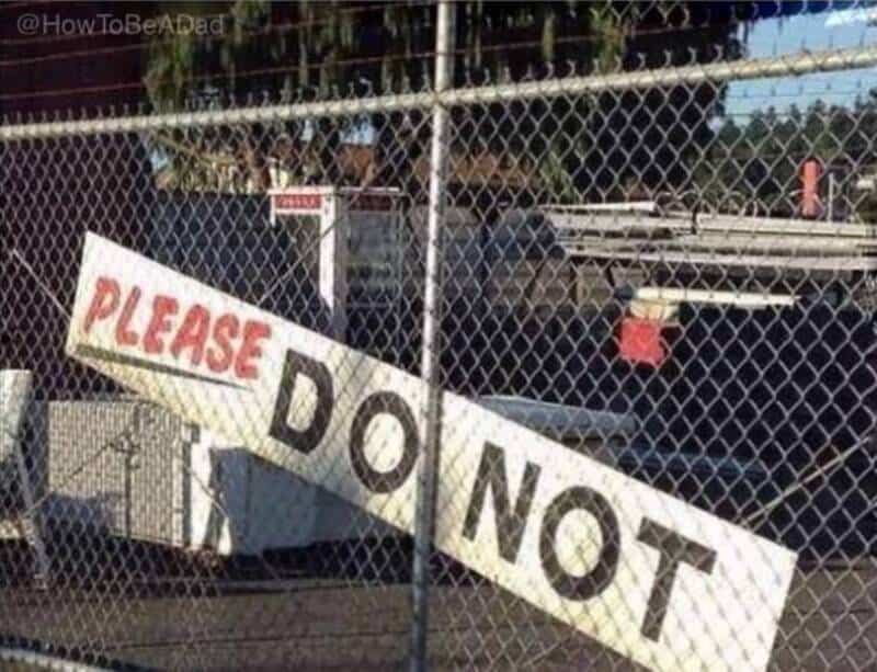 Sign on fence says 'PLEASE DO NOT' with the rest of the message obscured.