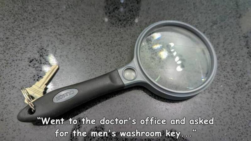 Magnifying glass with keys on a black surface, caption about asking for a washroom key.